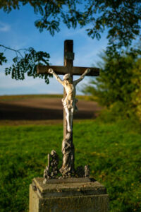 A roadside cross standing by the road among Moravian fields