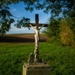 A roadside cross standing by the road among Moravian fields