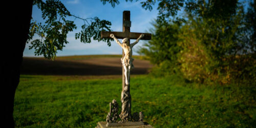A roadside cross standing by the road among Moravian fields