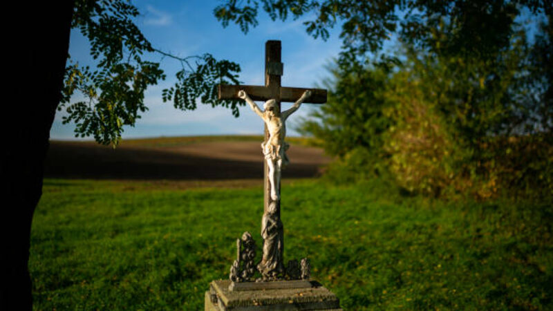 A roadside cross standing by the road among Moravian fields