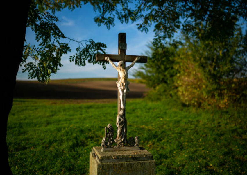A roadside cross standing by the road among Moravian fields